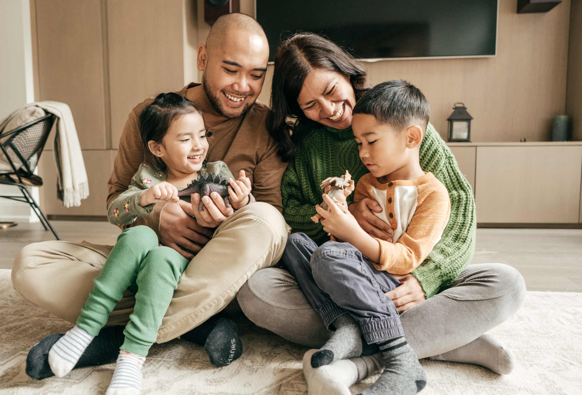 Photo of family embracing each other at their home