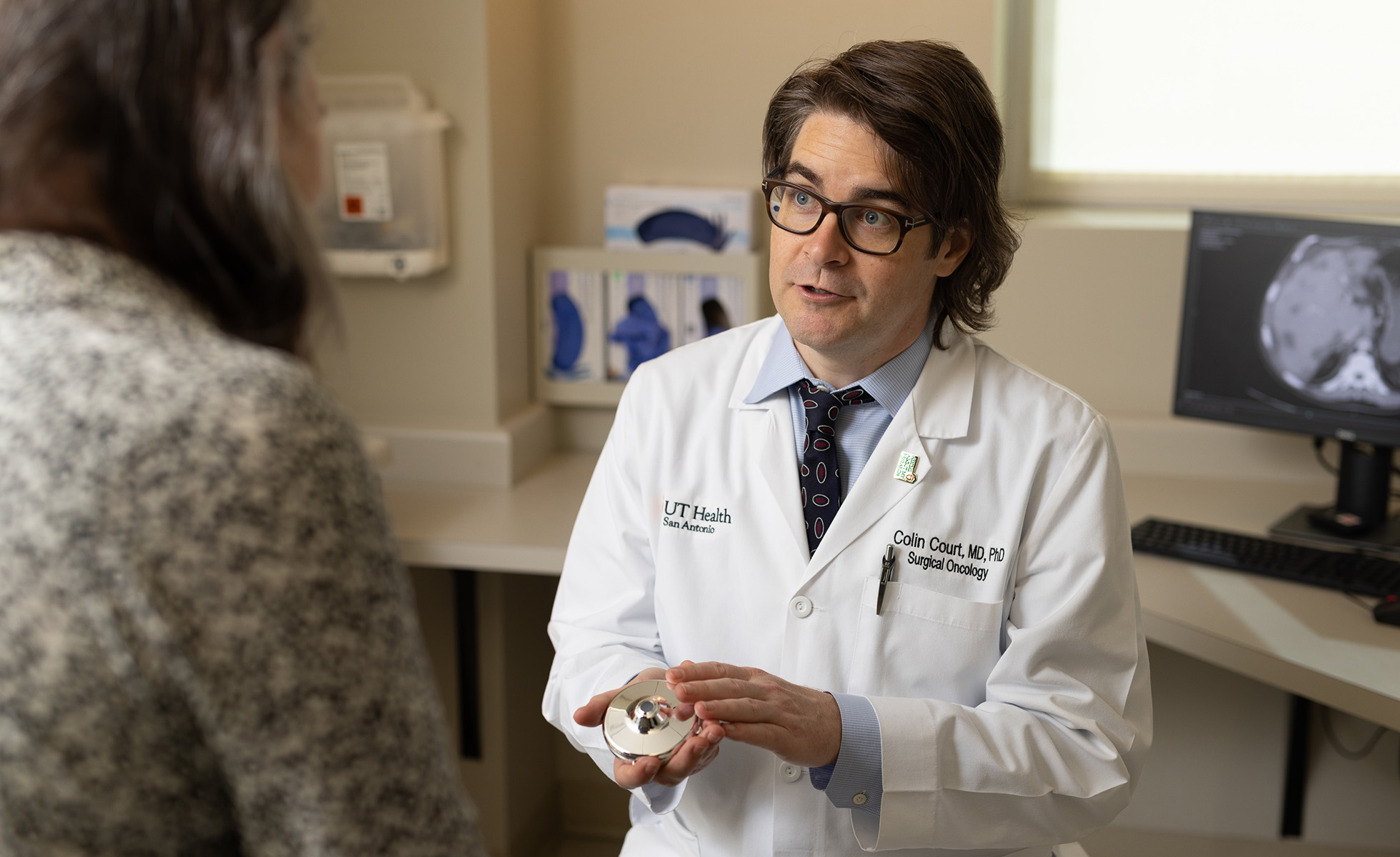 Dr. Court showing the HAI pump device to a patient