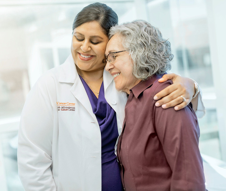 Dr. Arora hugging a patient