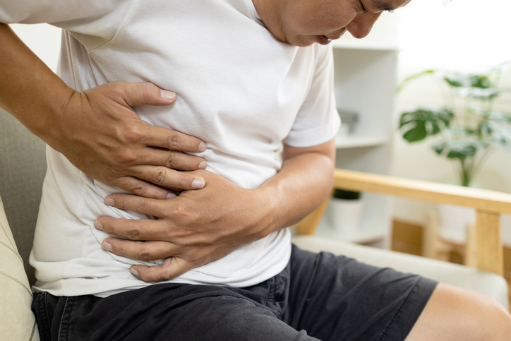 male patient with abdominal pain on right side belly,painful in abdomen,irritable bowel,middle-aged man holds under the ribs,stomach ache,cirrhosis of the liver disease,liver cancer 