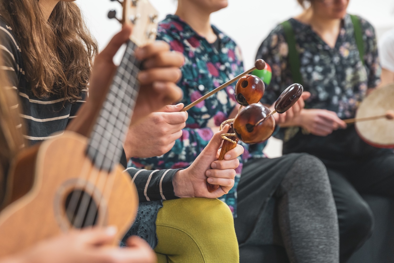 People playing on instruments during music therapy