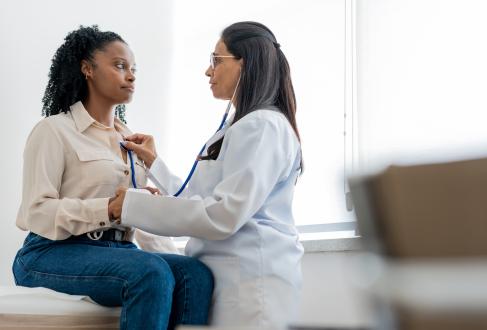 Doctor checking patients heart with stethoscope