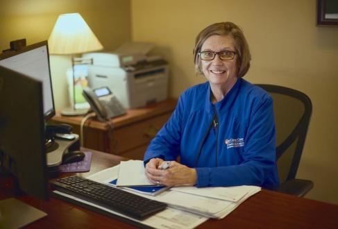 Carol Sherman working at her desk