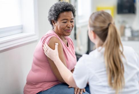 Black woman getting a vaccination 