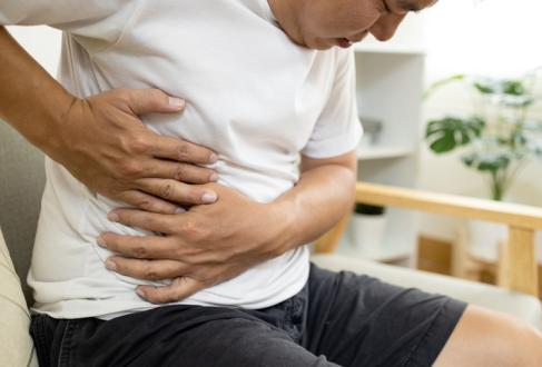 male patient with abdominal pain on right side belly,painful in abdomen,irritable bowel,middle-aged man holds under the ribs,stomach ache,cirrhosis of the liver disease,liver cancer 