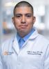 Daniel Pizana in a white coat